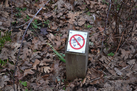 Sign on short post – walking restricted in this area Sign on short post – walking restricted in this area